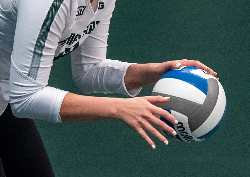 <p>Junior setter Elena Shklyar (12) prepares to serve the ball in the second set. The Spartans were shut out by the Nittany Lions, 3-0, on March 20, 2021. </p>
