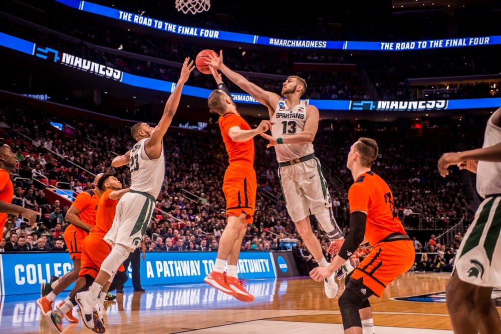 <p>Freshman forward Xavier Tillman (23), &nbsp;Bucknell guard Kimbal Mackenzie (1), and senior guard Ben Carter reach for the ball during their first game of the NCAA tournament against Bucknell on March 16, 2018 at Little Caesars Arena. The Spartans defeated the Bison 82-78.&nbsp;</p>