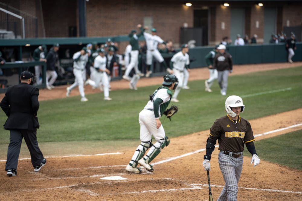 <p>Michigan State players spill out of the dugout celebrating as the final out is made in their home opener on March 22, 2023. Michigan State triumphed 8-3.</p>