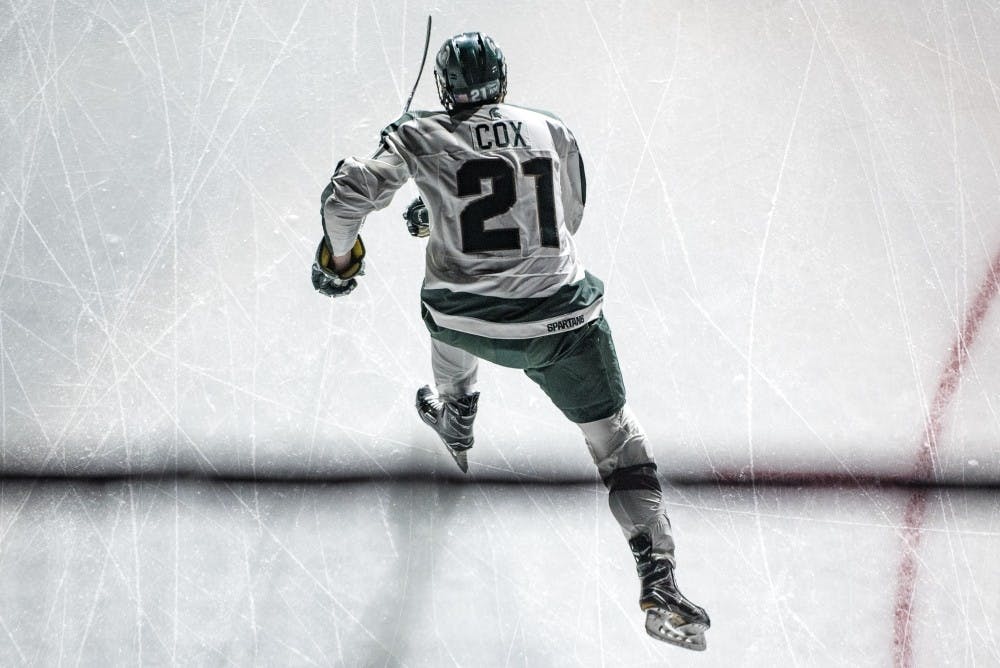 <p>Senior forward Joe Cox (21) skates before the game against Penn State on Feb. 25, 2017 at Munn Ice Arena. The Spartans were defeated by the Nittany Lions, 4-1.</p>