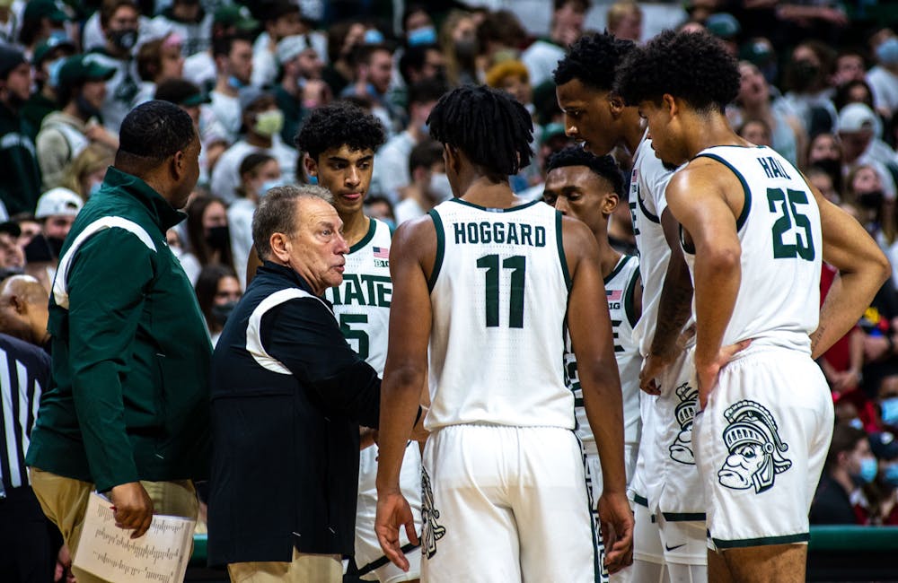<p>Coach Tom Izzo talks to his team during an unofficial time out while referees rewatch footage in the second half. The Spartans beat the Cardinals, 73-64, to win the B1G/ACC Challenge on Dec. 1, 2021. </p>
