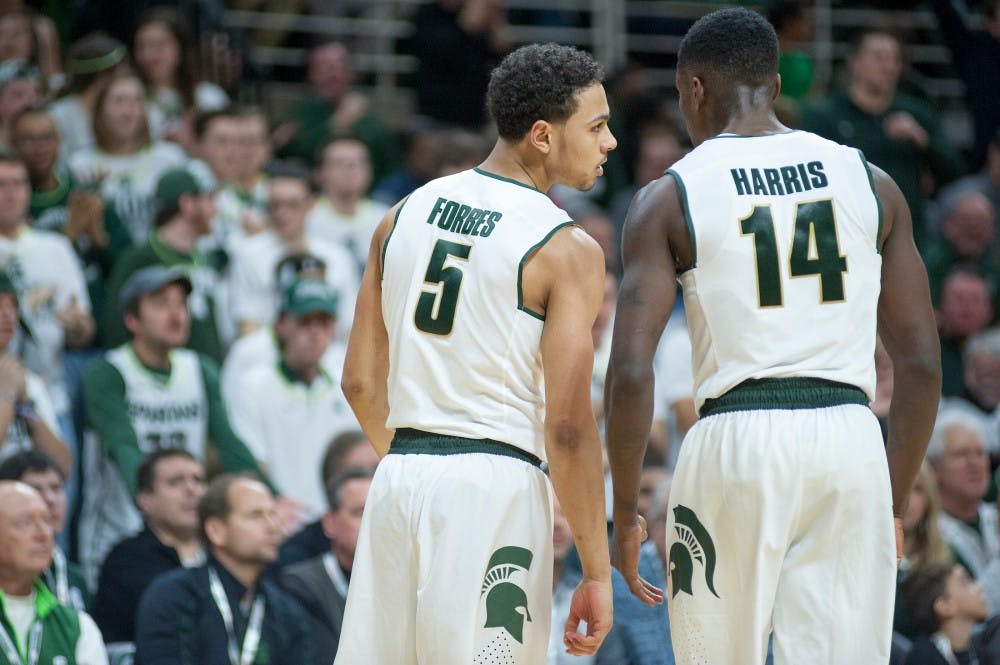 Senior guard Bryn Forbes talks to junior guard Eron Harris during the game against Iowa on Jan. 14, 2016 at Breslin Center. The Spartans were defeated by the Hawks, 76-59 .