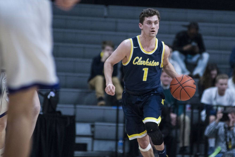 Clarkston guard Foster Loyer (1) brings the ball up the court during the MHSAA mens basketball class A semi-final game on March 23, 2018 at Breslin Center. The Wolves beat the Pilots, 72-49. (C.J. Weiss | The State News)