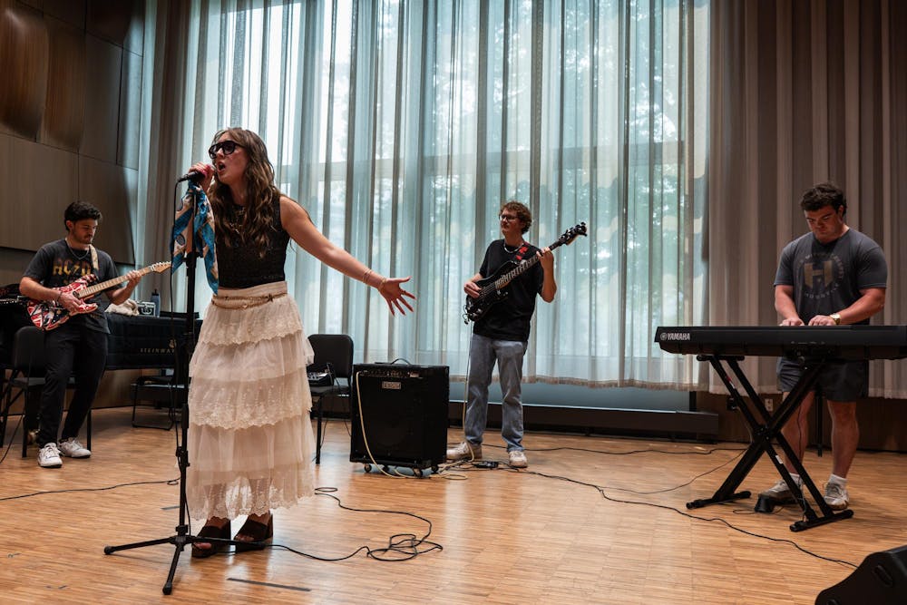 <p>Luke Karsten, Alina Morse, Kade Ringer and Kyle Quick (from left) practice for their band, Roxy Riot, at the MSU Music Building in East Lansing, Mich., on July 17, 2026.</p>