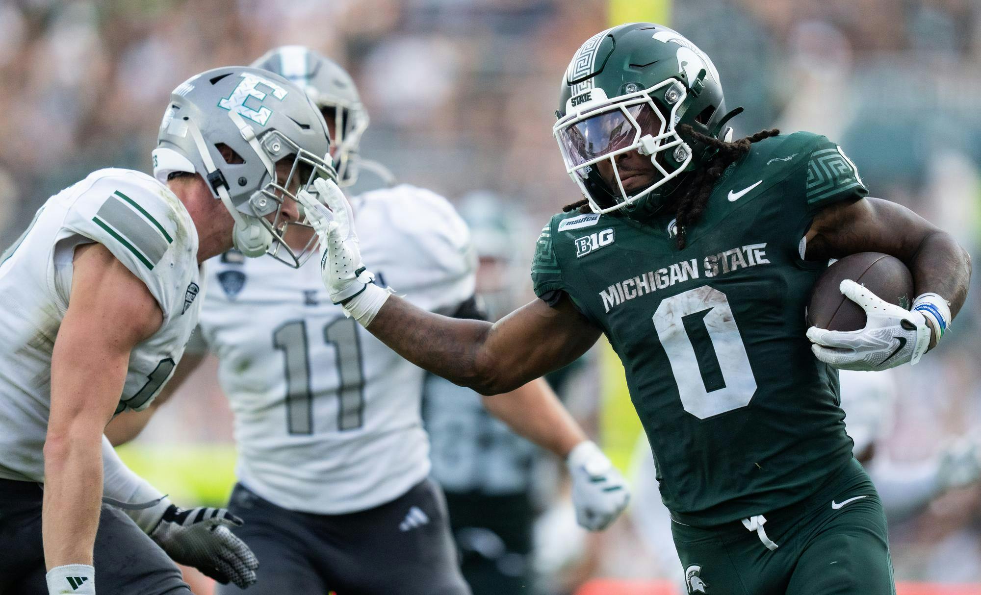 <p>Michigan State redshirt senior running back Cam Edwards (0) prepares to stiff arm an Eastern player as he runs the ball in Spartan Stadium in East Lansing, Mich., on Saturday, Sept. 12, 2026.</p>