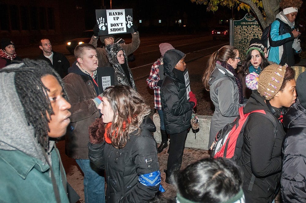 <p>Students and members of The Committee of Citizen Oversight of Police Officers protest to get in contact with the MSU Police Department's Chief of Police Nov. 13, 2014, at the MSU Police Department on Abbott Road. The committee claims that officers are accountable for their actions and should wear body cameras for evidence of their harassment towards citizens. The chief of police has declined their demands previously. Raymond Williams/The State News</p>
