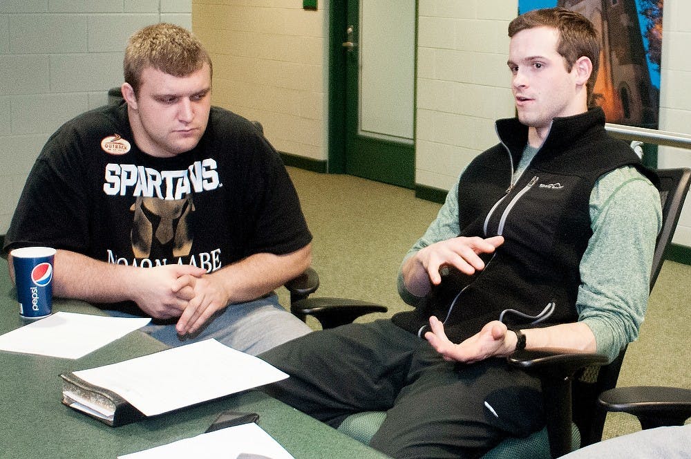 	<p>Junior quarterback Andrew Maxwell, right, talks with sophomore offensive guard and center Jack Allen along with the rest of a small group at the Athletes in Action meeting on Tuesday, Jan. 29, 2013 at the Skandalaris Football Center.  The Athletes in Action meetings allow athletes at <span class="caps">MSU</span> to discuss their religious beliefs with each other. Katie Stiefel/The State News</p>