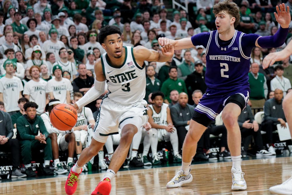 Junior guard Jaden Akins (3) attempts to maneuver around University of Northwestern players during a match at the Breslin Center on March 6, 2024. The Spartans defeated the Wildcats with a score of 53-49. 