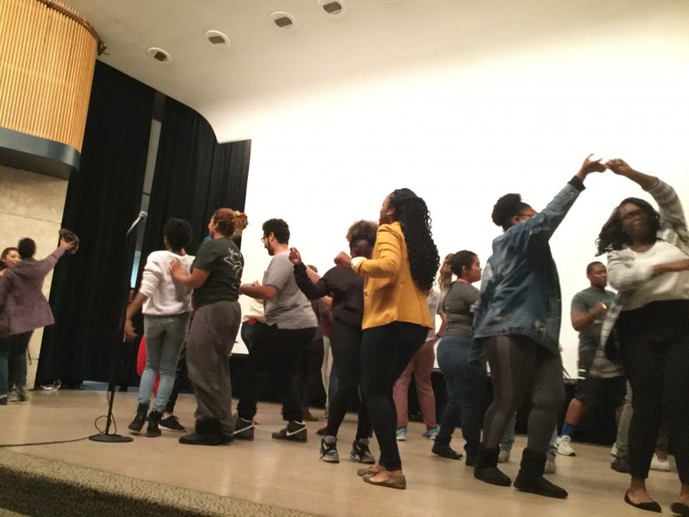 <p>Attendees at the 14th annual Brown Pride event dance together after being invited on stage by the night's emcees. The event was marked by a recurring theme of celebration and unity. Photo by Maxwell Evans.</p>