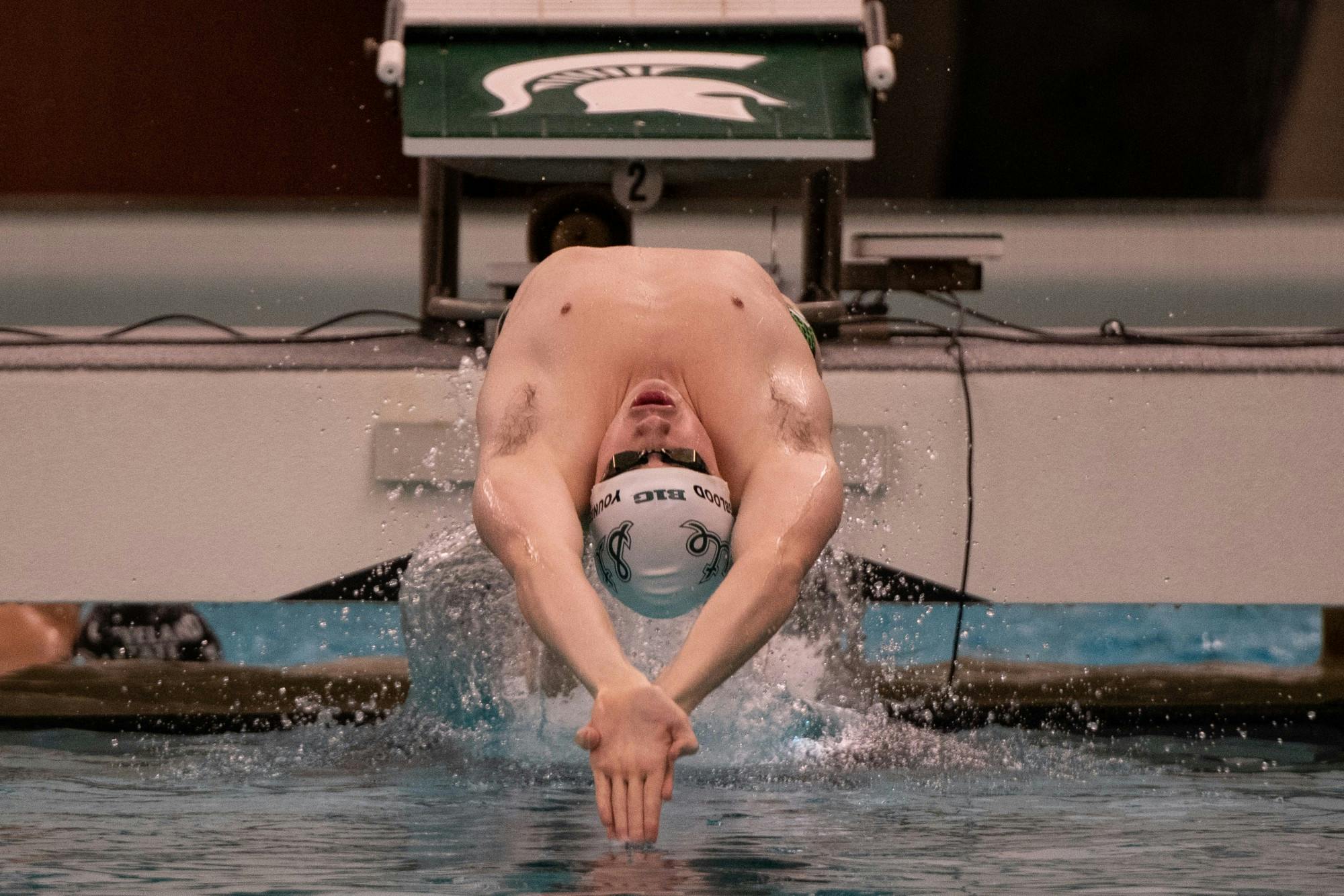 <p>Junior Weston Youngblood begins a race during the meet against Cleveland State on Jan. 24 at McCaffree Pool. The Spartans defeated the Vikings, 163.5-135.5.</p>