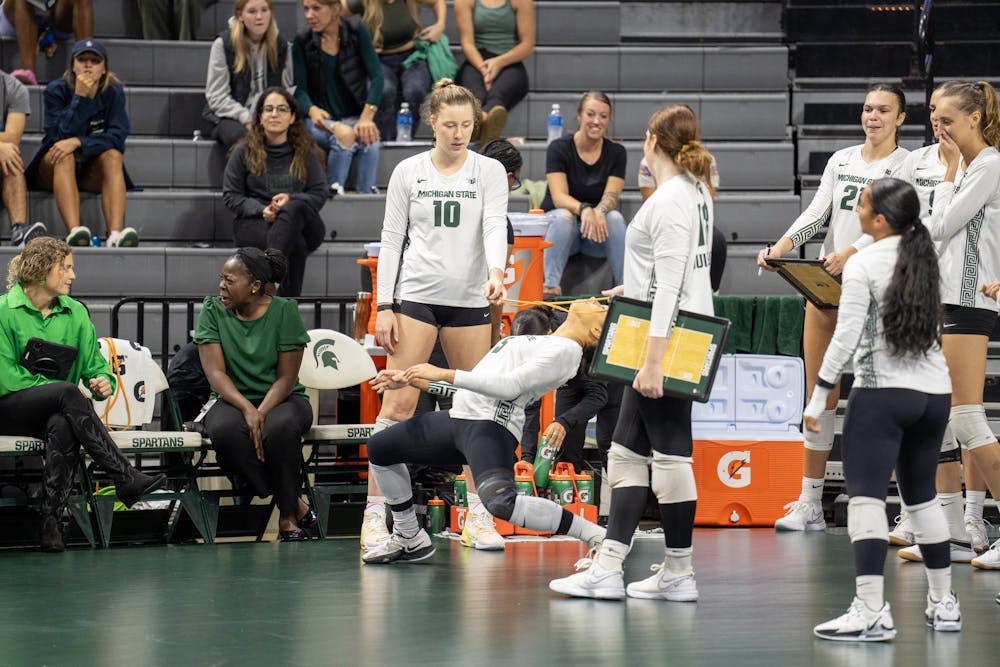 <p>Michigan State Volleyball players Meredith O'Gorman (10), Maya Clayton (5), and Rachel Muisenga (18) limbo during a media timeout while facing Rutgers in East Lansing on Oct. 1, 2023. Michigan State went on to defeat Rutgers in four sets in the Jack Breslin Student Events Center.</p>