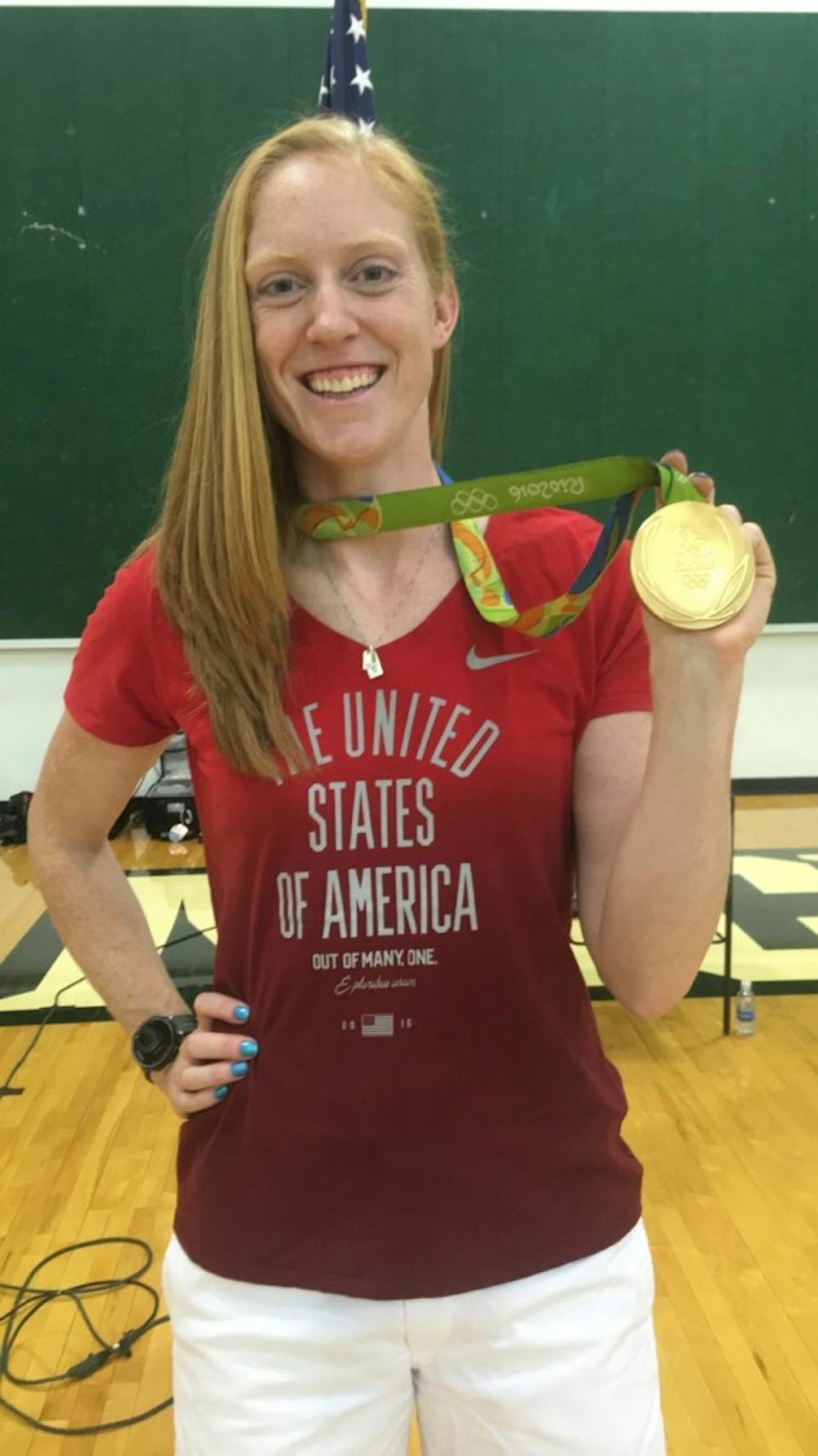<p>MSU alumna Emily Regan displays her gold medal. Regan won gold in rowing.</p>