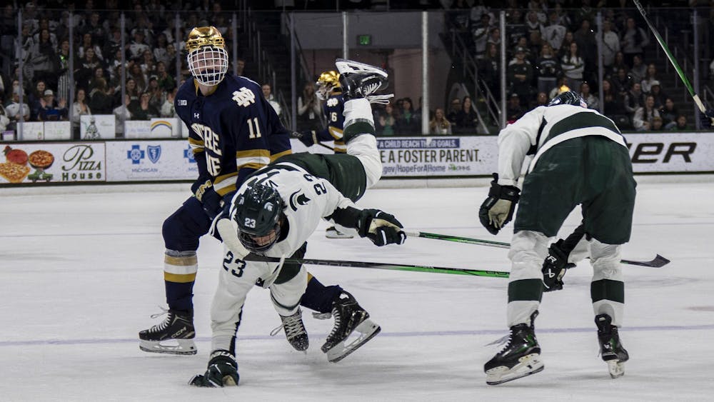 <p>MSU freshman forward Shane Vansaghi (23) gets checked by Notre Dame sophomore forward Danny Nelson (11) at Munn Ice Arena on Nov. 15, 2024. Michigan State took the win 8-3.</p>