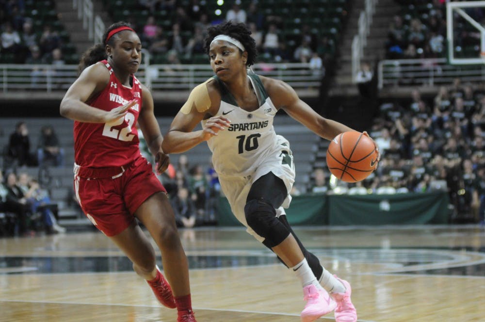 Redshirt senior Branndais Agee (10) goes against Wisconsin's forward Niya Beverly (22) during the women's basketball game against Wisconsin on Feb. 21, 2018 at Breslin Center. The Spartans defeated the Badgers, 69-61. (Annie Barker | The State News)
