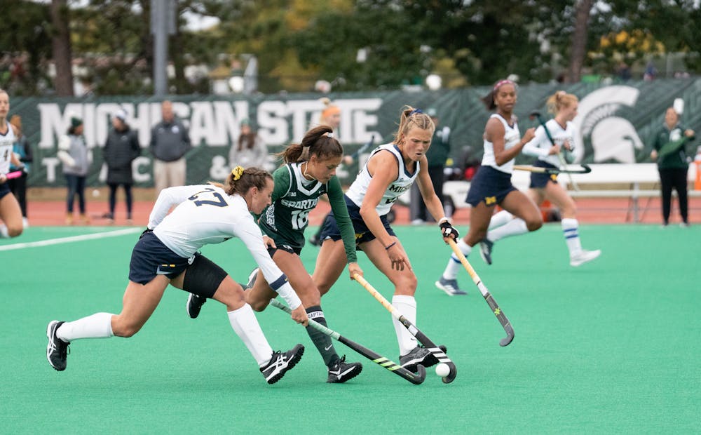 <p>Midfielder Merel Hanssen pushes past her Wolverine opponents to get control of the ball, Oct. 7, 2022.﻿</p>