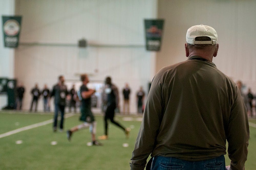 <p>Miami Dolphins Scout Ron Labadie watches a drill Mar. 18, 2015, during Pro Day at the Duffy Daugherty Building. NFL scouts and coaches came to the event to check out Spartan NFL prospects. Kelsey Feldpausch/The State News</p>