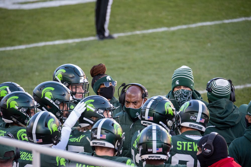 <p>Michigan State head football coach Mel Tucker in a huddle with his players during the Northwestern matchup on Saturday, Nov. 28, 2020.</p>