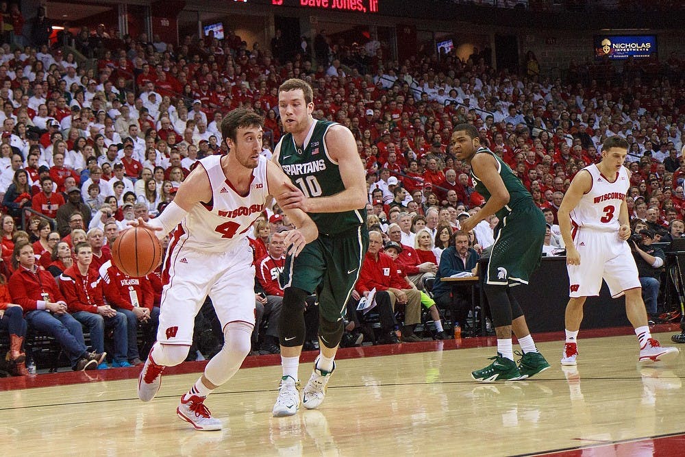 <p>Wisconsin guard Matt Ferris drives the ball down the court while being guarded by junior forward Matt Costello on March 1 during the game at Kohl Center in Madison, Wisconsin. The Spartans were defeated by the Badger, 68-61. Photo Credit: Jason Chan / The Badger Herald</p>