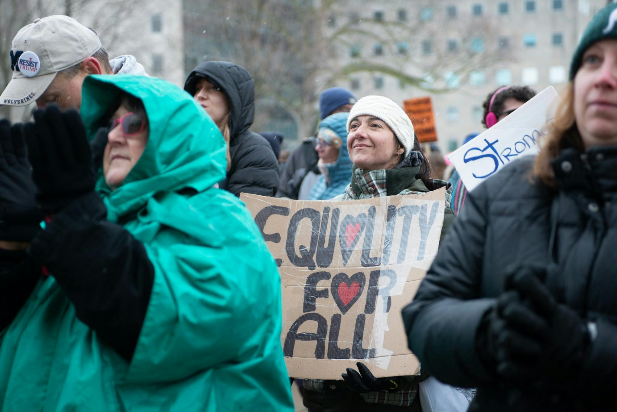 Arshia Ebrahimi,  a psychologist from Mount Pleasant, displays her poster during the Women’s March On Lansing 2020 Jan. 18, 2020, hosted by the Blue Brigade. Arshia is a Middle Eastern woman who believes that "if all minorities got together, we'd be the majority."