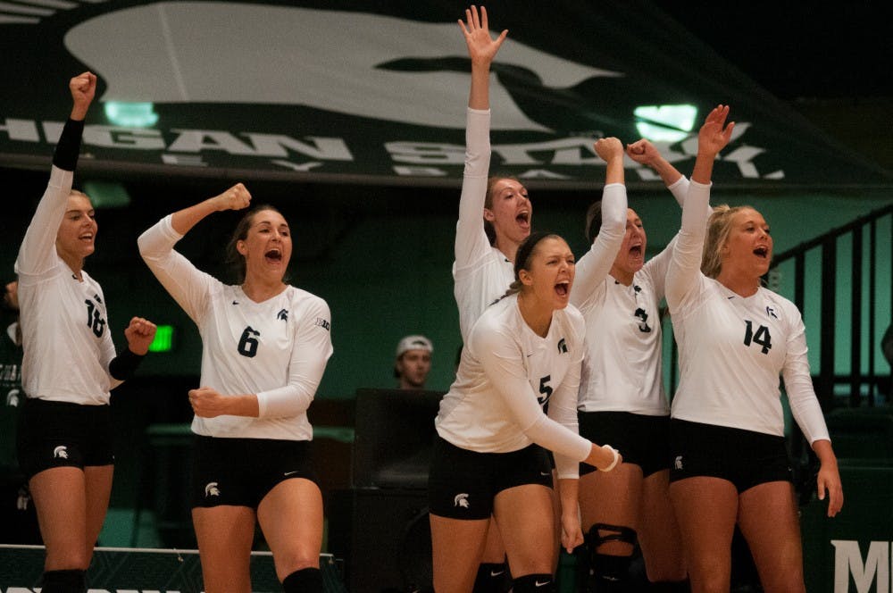 The Spartans celebrate from the sideline after the team scored a point during the game against Maryland on Oct. 8, 2016 at Jenison Field House.  The Spartans defeated the Terrapins, 3-1. 