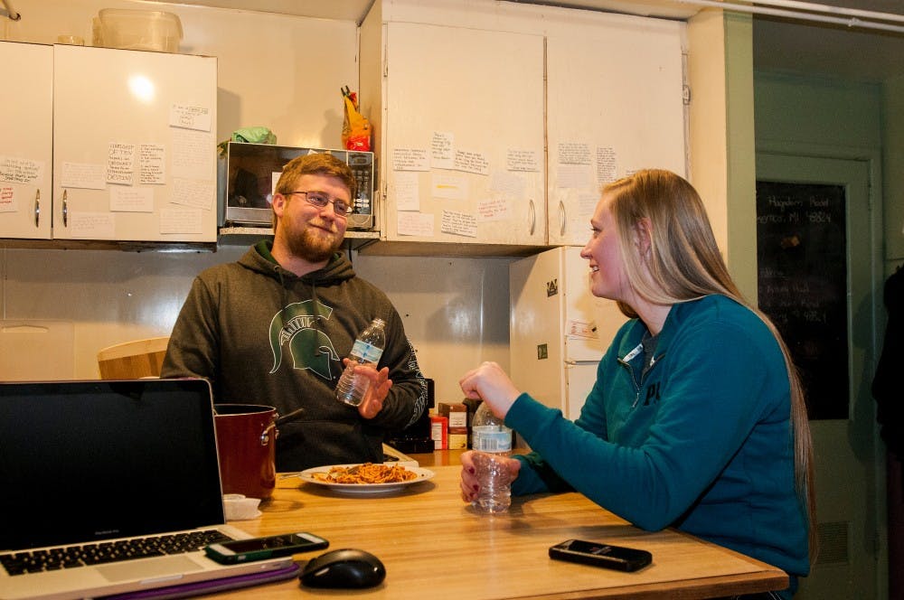 Agribusiness management junior Emily Hale, right, listens as animal science junior David Scales tells a story in her room on Jan. 19, 2016 at the Sheep Teaching and Research Center on 3885 Hagadorn Road in Okemos, Mich. Hale is the only student currently living at the sheep farm. 