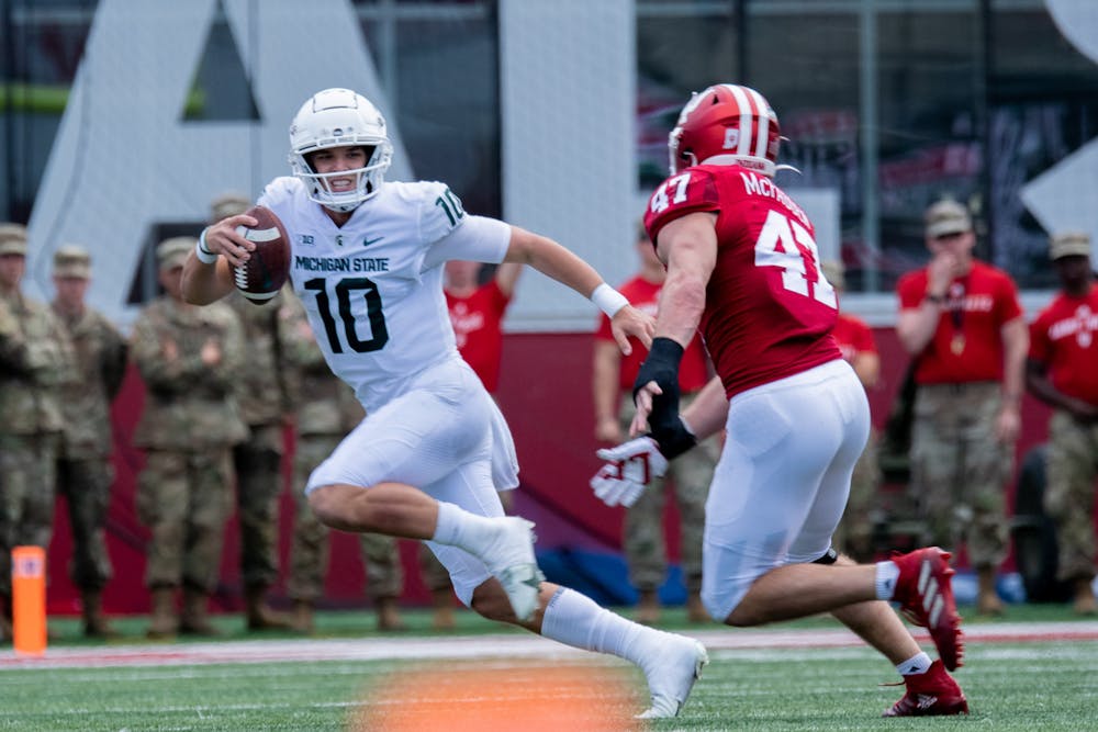 <p>Redshirt sophomore quarterback Payton Thorne scrambles with the ball. The Spartans found a way to hold on against the Hoosiers with a 20-15 win, scraping to their first 7-0 start since 2015 on Oct. 16, 2021.</p>