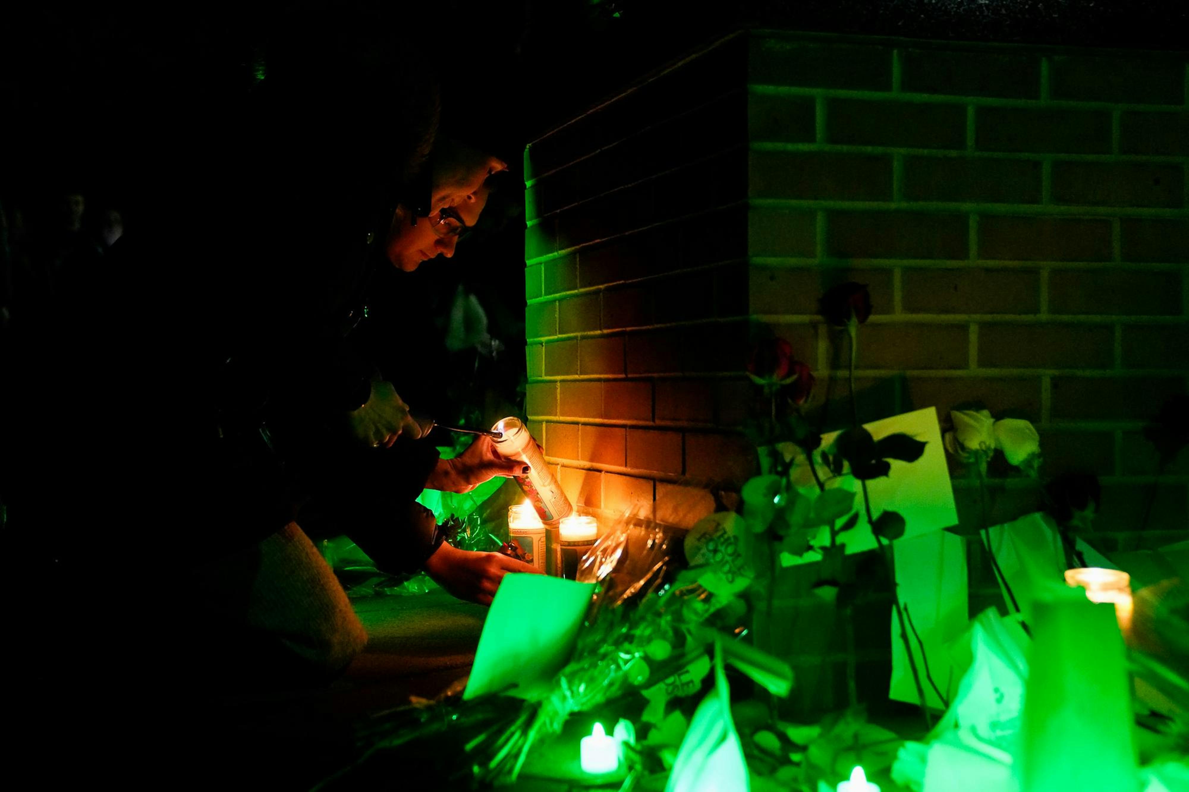 Community members light three candles during a luminary vigil in memory of Brian Fraser, Arielle Anderson and Alexandria Verner, who were killed last year in a mass shooting on campus on Feb. 13, 2024. 