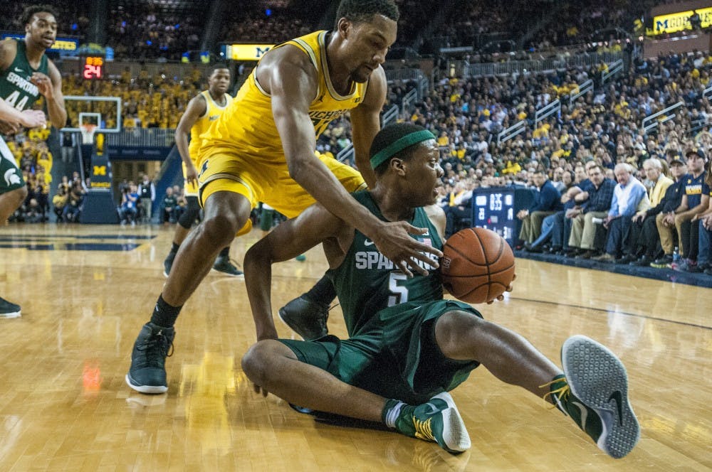 Freshman guard Cassius Winston (5) holds the ball as Michigan guard and forward Zak Irvin (21) attempts to strip the ball away during the men's basketball game against the University of Michigan on Feb. 7, 2017 at Crisler Arena in Ann Arbor, Mich. The Spartans trailed the Wolverines at the half, 55-29. 