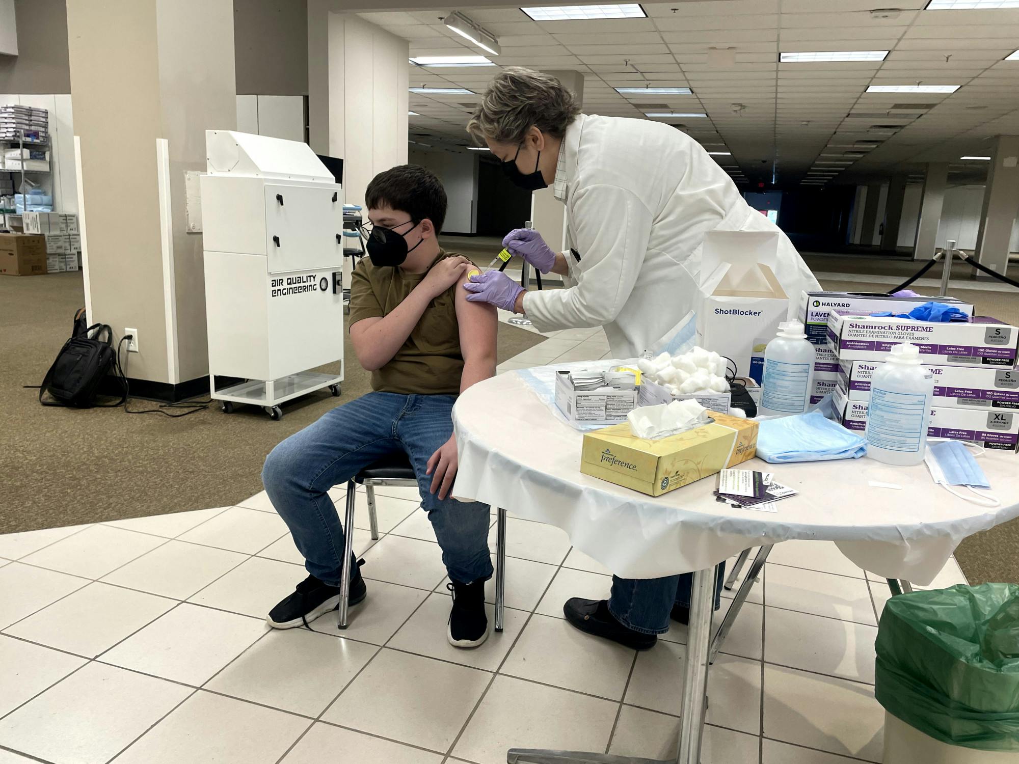 <p>Evan Yaney receives first dose of the Pfizer COVID-19 vaccine from Dr. Annette Kopachik. </p>