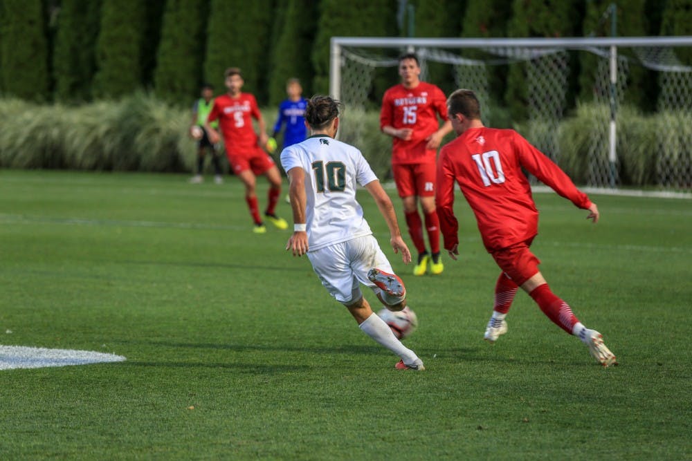 <p>Then-junior midfielder Giuseppe Barone (10) runs with Rutgers forward Brian Hawkins (10) during the game against Rutgers on Sept. 21, 2018. The Spartans defeated the Scarlet Knights, 2-1.</p>