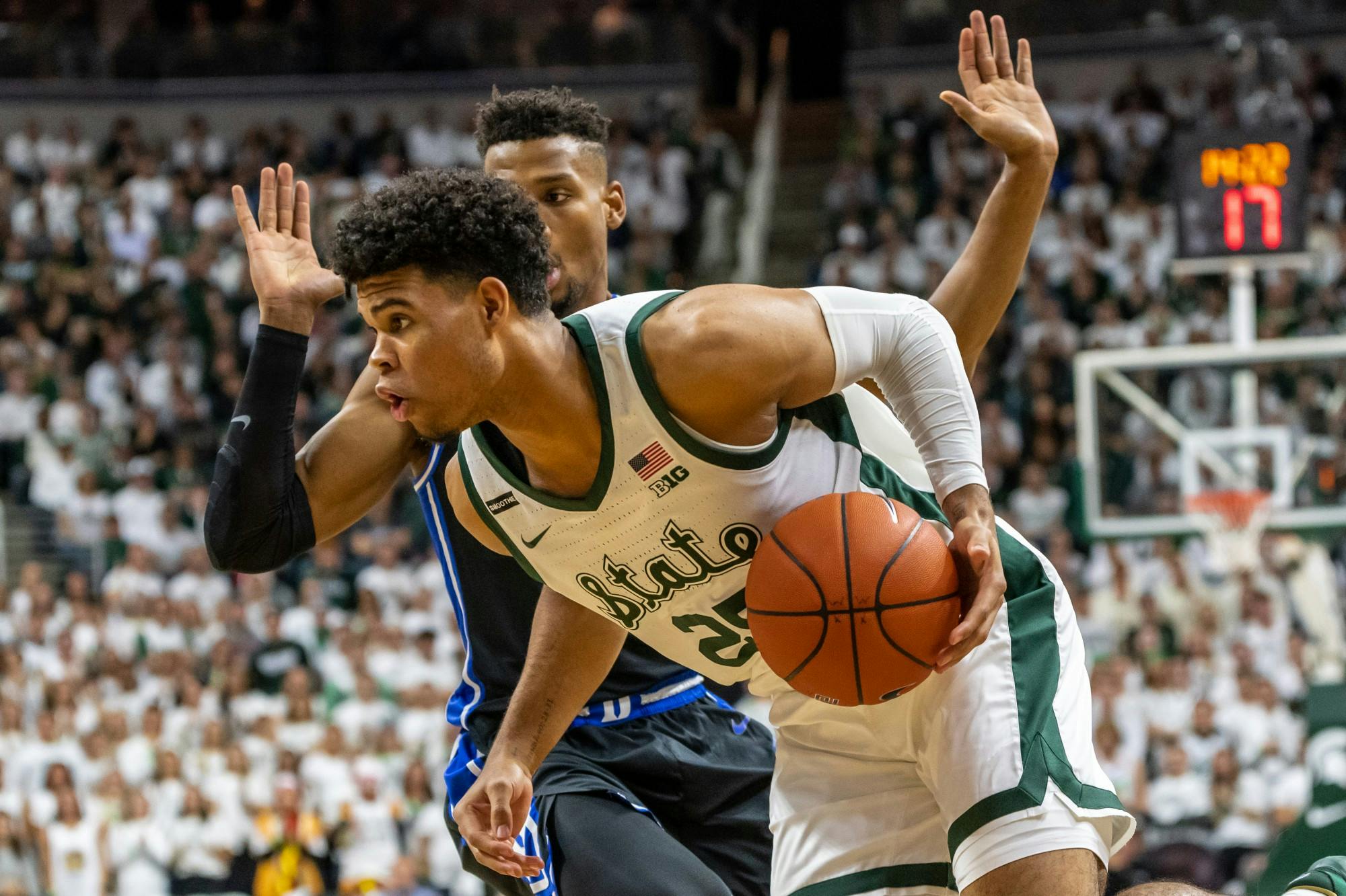 Freshman forward Malik Hall (25) drives on a Duke defender.