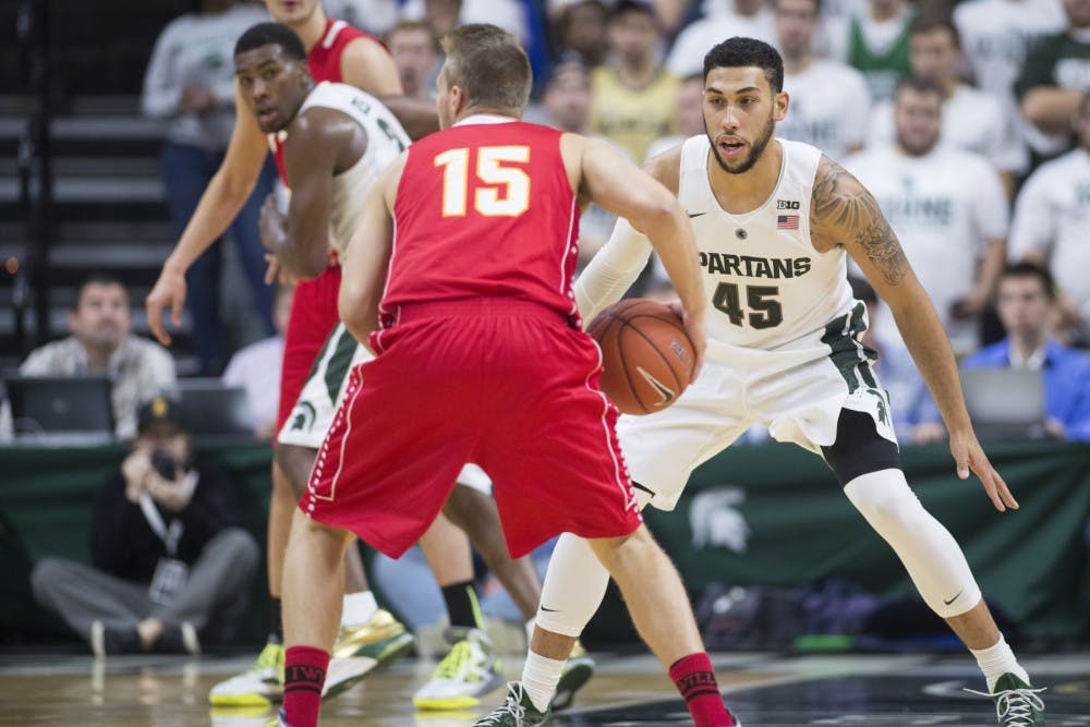 <p>Senior guard Denzel Valentine defends Ferris State wing Greg Williams on Nov. 9, 2015 during the first half of the game against Ferris State at Breslin Center. The Spartans defeated the Bulldogs, 93-57. </p>