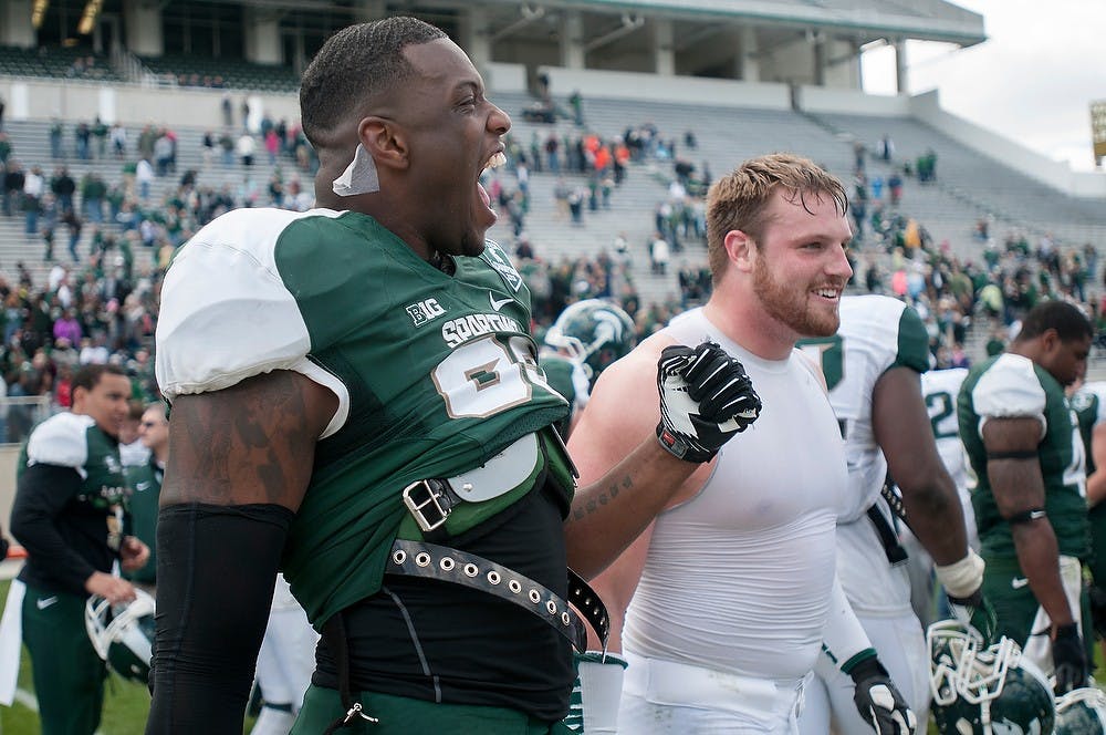 <p>Junior defensive end Shilique Calhoun cheers April 26, 2014, after the Spring Green and White game at Spartan Stadium. The White team won, 20-13. Julia Nagy/The State News</p>