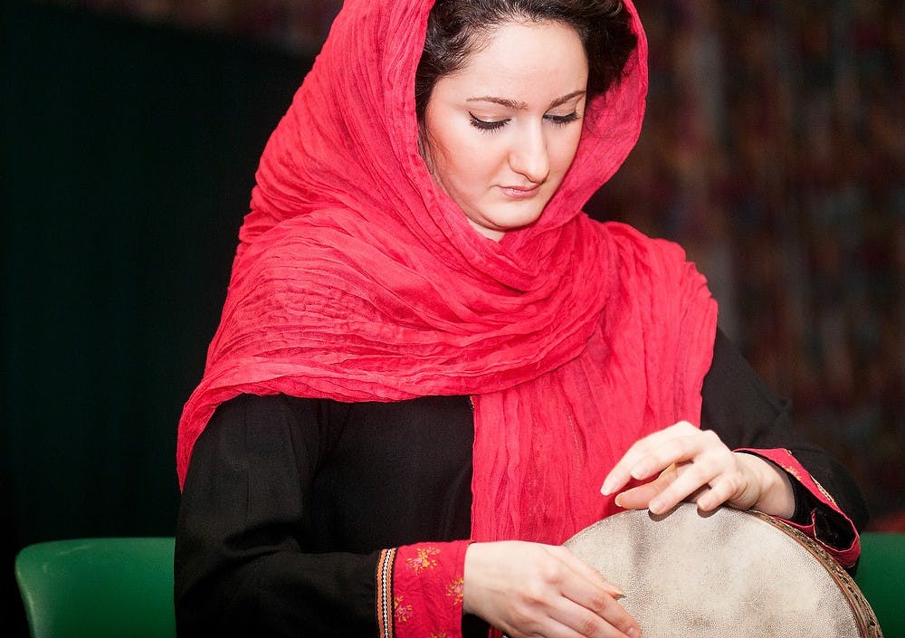 	<p>Graduate student Elaheh Esfahanian plays a tombak drum in celebration of Yalda night Friday, Jan. 18, 2013, in the Spartan B and C rooms of the International Center. The <span class="caps">MSU</span> Persian Student Association hosted the International Coffee Hour to promote and celebrate the holiday typically celebrated at the winter solstice. Danyelle Morrow/The State News</p>