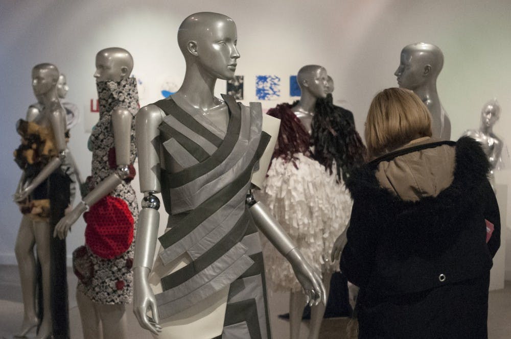 Associate professor of apparel and textile design Sally Helvenston Gray browses the Apparel and Textile Design Exhibition on Nov. 28, 2016 Kresge Art Center. Helvenston Gray said that the exhibition focuses on details best seen up close and stationary.