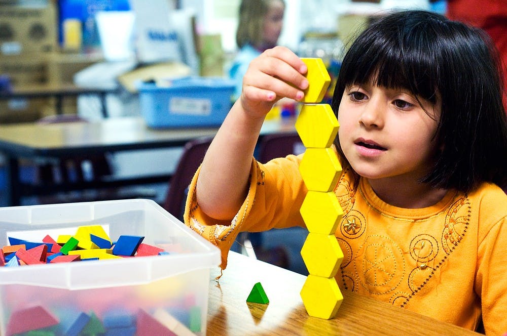 	<p>East Lansing resident Hawrua Razzaa plays with pattern blocks on June 12, 2011 at the Red Cedar Elementary School. </p>