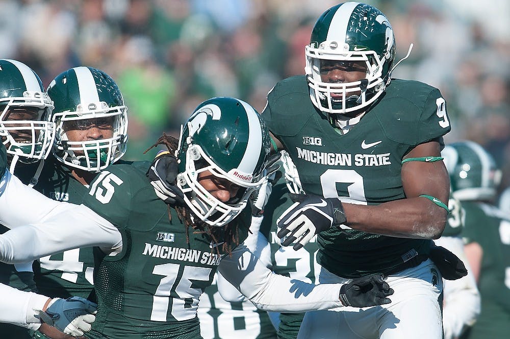 	<p>Senior safety Isaiah Lewis, 9, celebrates with sophomore cornerback Trae Waynes after Waynes intercepted the ball Nov. 30, 2013, during the game against Minnesota at Spartan Stadium. The Spartans lead at the half 7-3. Julia Nagy/The State News</p>