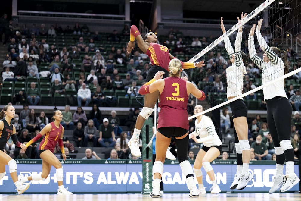 USC senior middle blocker Rylie McGinest (22) spikes the ball during the volleyball match against the Trojans