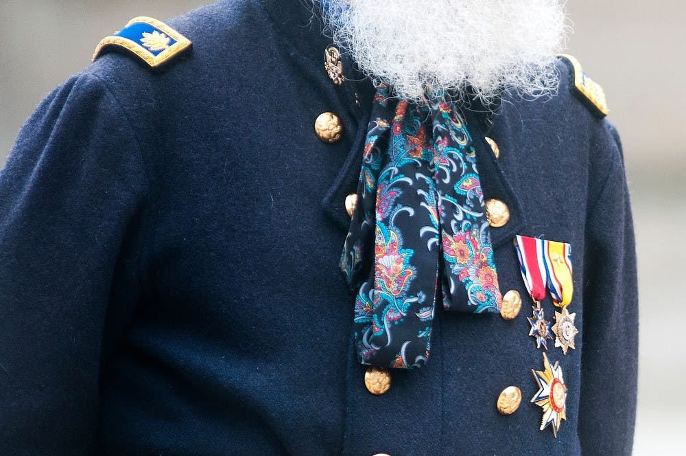 	<p>Holt, Mich., resident Keith Harrison stands in Civil War era attire to listen to the 5th Michigan Regiment band, June 1, 2013, on the Capitol lawn. The band, with members from across the state of Michigan, was performing music arranged during the Civil War with antique or replica instruments. Danyelle Morrow/The State News</p>