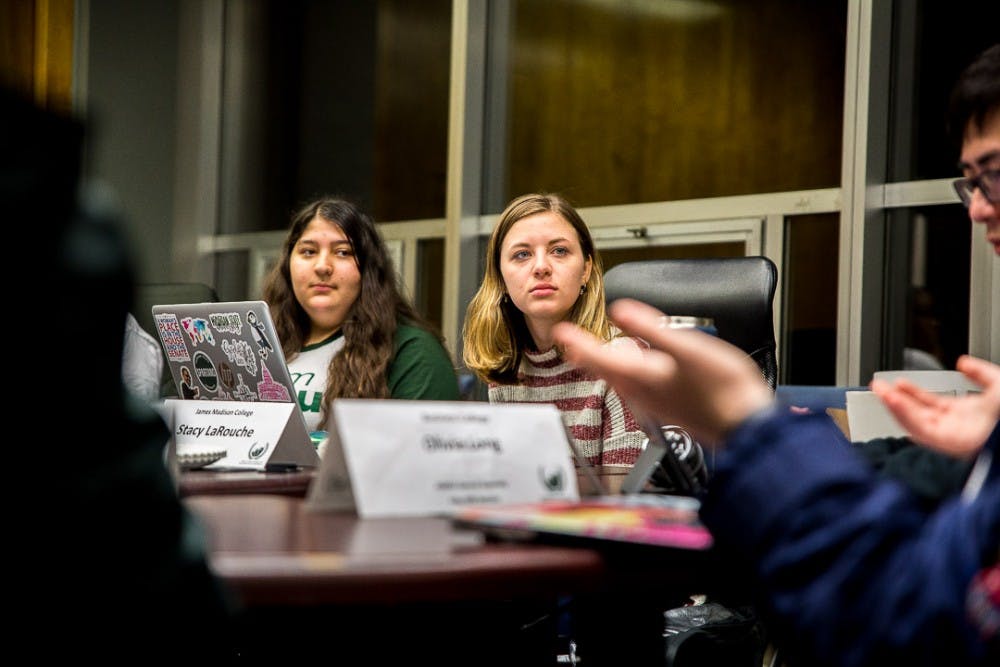 James Madison College Representative Stacey LaRouche listens to a committee member speak during an ASMSU meeting on Jan. 24, 2019, at the Student Services Building.