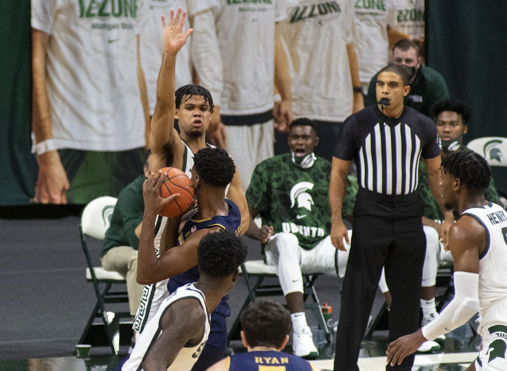 Sophomore forward Malik Hall (25) sticks his arm out to block a shot attempt against Notre Dame in the first half. REST OF CAPTION TBD