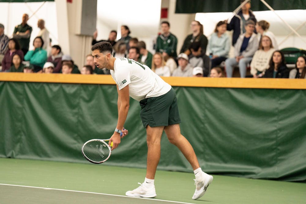 <p>Freshman Ozan Baris prepares to serve during his singles match against Northwestern on Sunday, April 23 at the MSU Indoor Tennis Center.</p>