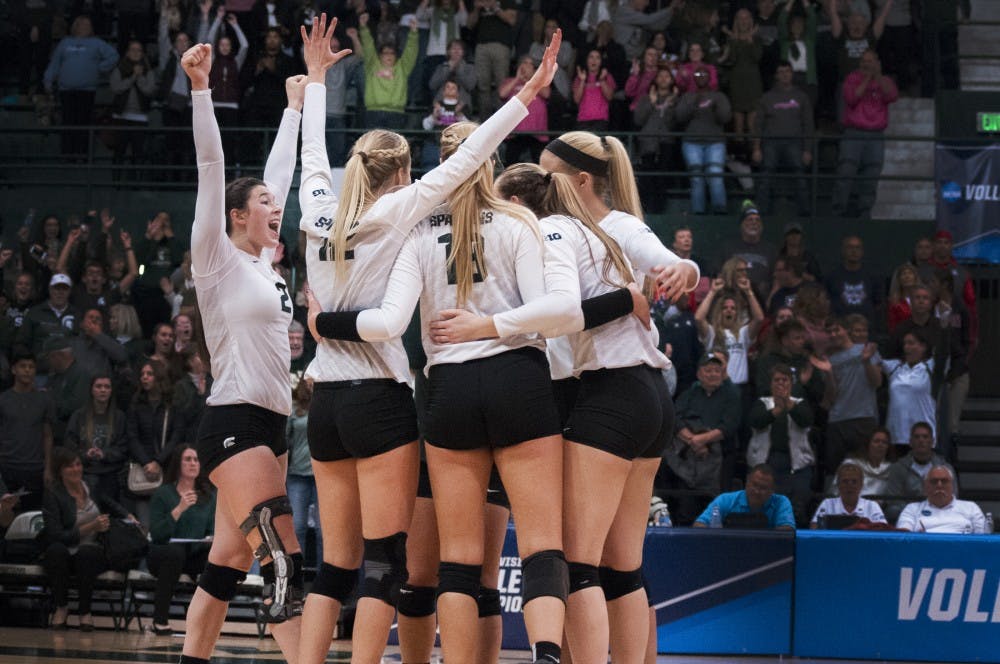 The Spartans celebrate after scoring a point during the game against Arizona on Dec. 3, 2016 at Jenison Field House. The Spartans were defeated by the Wildcats, 3-2.