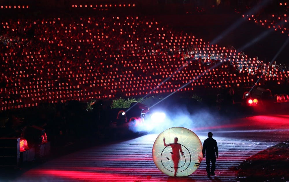 A person walks in a plastic ball with a happy face on it during the Opening Ceremonies of the 2012 Olympics at Olympic Stadium in London, England. The theme is "This is for everyone," and the volunteer cast is 7,500 strong. (Robert Gauthier/Los Angeles Times/MCT)