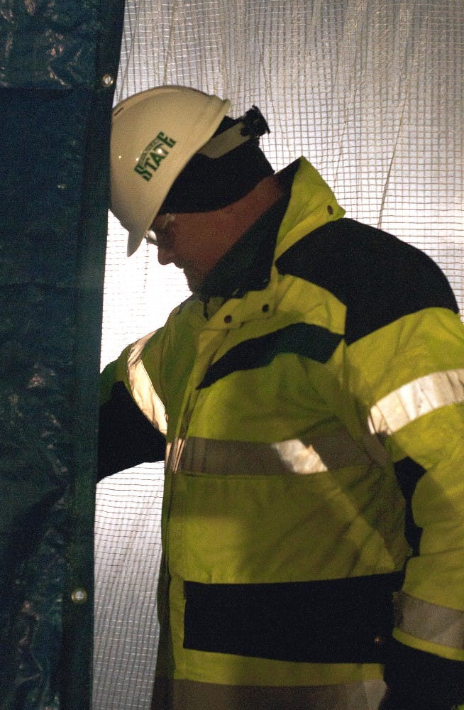 <p>Conventional Facilities and Infrastructure Deputy Director Chris Thronson makes his way out onto the construction site Mar. 3, 2015, at the Facility for Rare Isotope Beams (FRIB), 640 S. Shaw Lane. Thronson said the FRIB project is eight weeks ahead of schedule, and is slated for completion in 2019. Alice Kole/The State News</p>