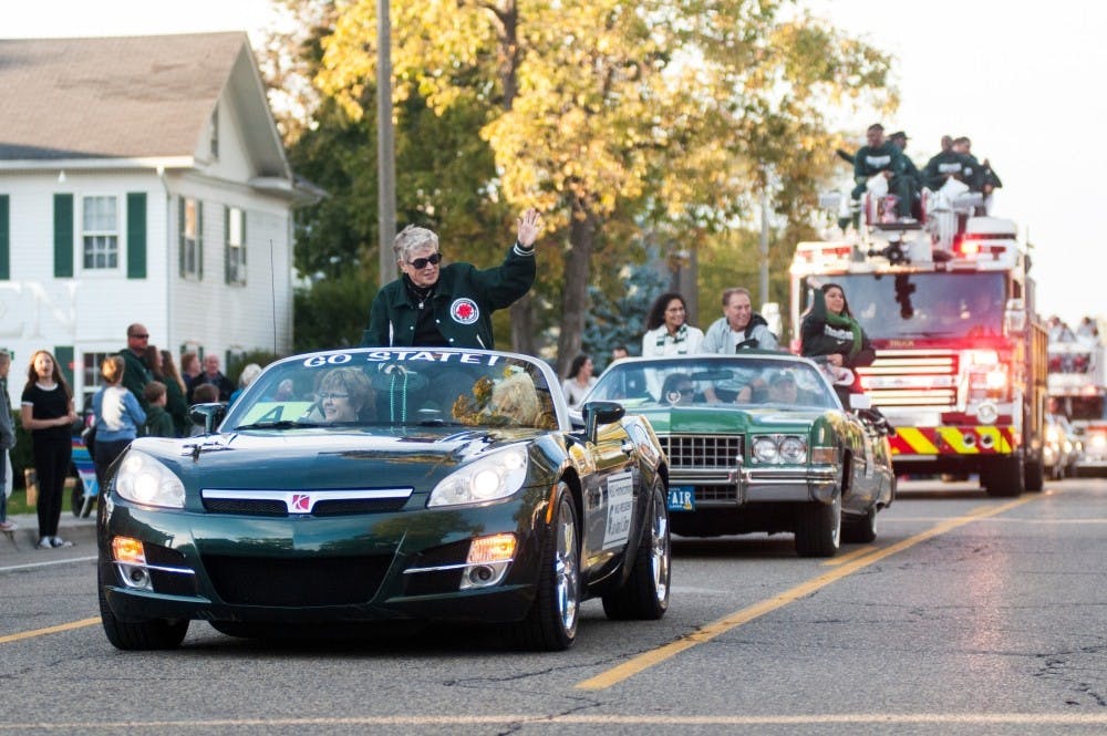 <p>MSU President Lou Anna Simon waves to the crowd during the Homecoming Parade on Oct. 14, 2016 along Abbot Road.</p>