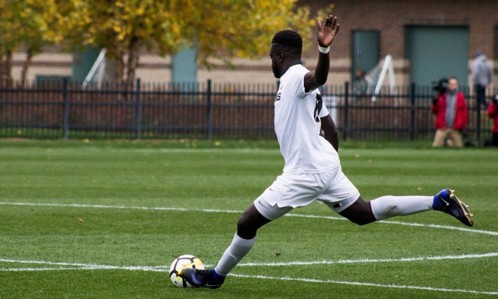 Sophomore defender Michael Wentungu (17) gets rid of the ball during the game against Indiana on Oct. 29, 2017, at DeMartin Stadium. The Spartans and the Hoosiers tied 1-1 in double overtime.