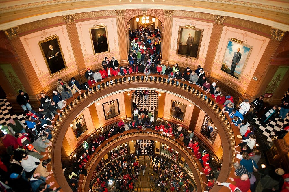 	<p>Hundreds gather at the rotunda, Tuesday, Dec. 11, 2012, at the state Capitol in Lansing. The building was opened at 7:30 a.m. Tuesday as thousands participated in the rally to protest right-to-work laws both inside and outside the building. Justin Wan/The State News</p>