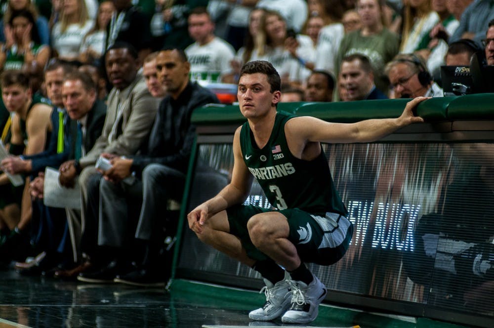 <p>Junior guard Foster Loyer (3) watches from the sideline during the game against Tenessee Tech. on Nov. 18, 2018 at the Breslin Center. The Spartans beat the Golden Eagles, 101-33.</p>