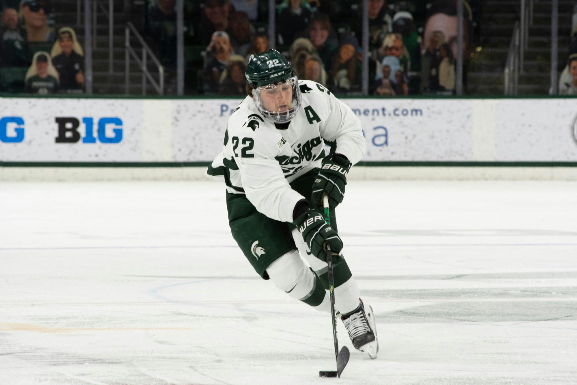 <p>Michigan State&#x27;s Dennis Cesana retrieves the puck in the Spartans&#x27; loss to Notre Dame on Feb. 26, 2021.</p>